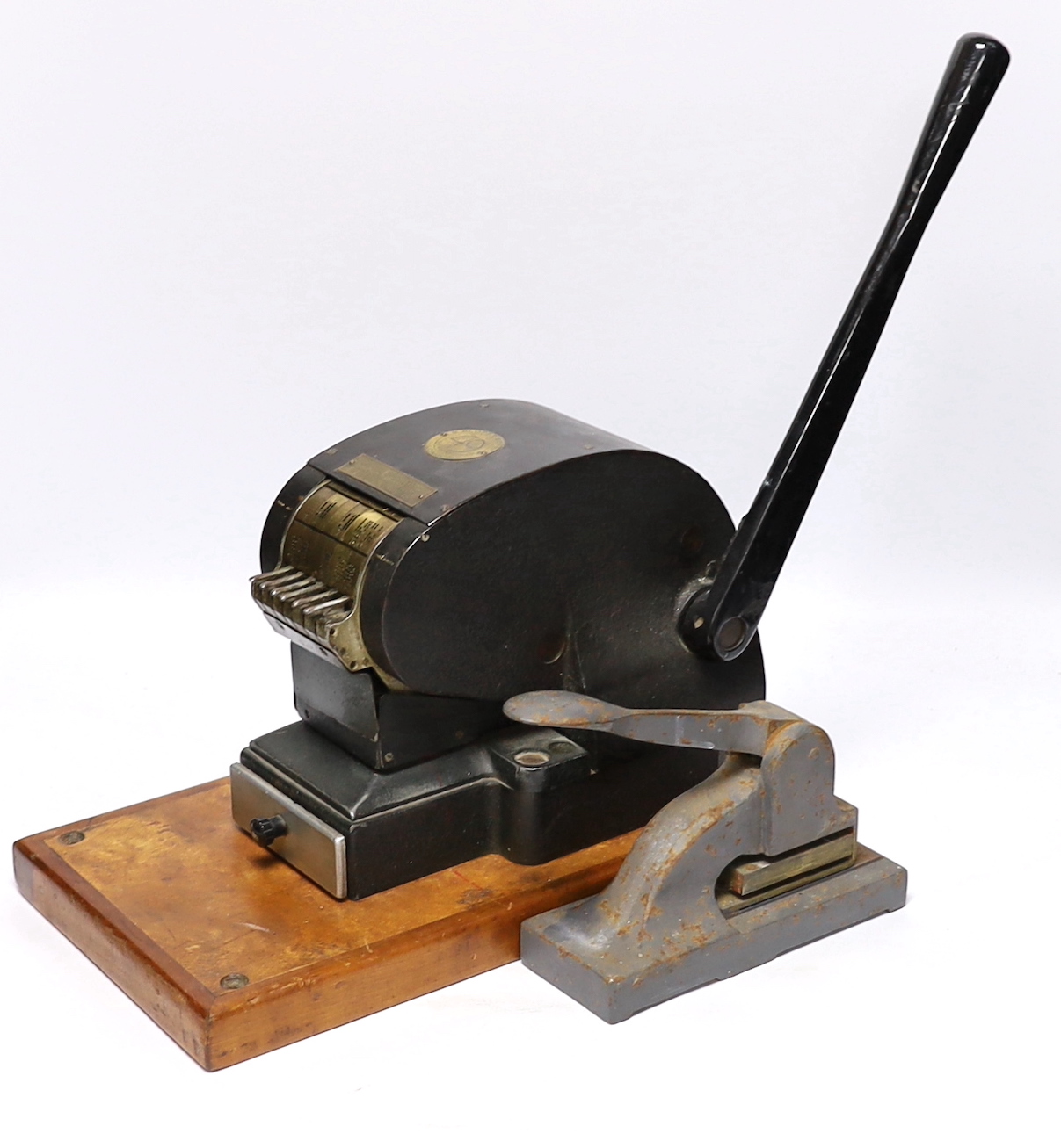 Two stamp perforators, a large example with adjustable date wheels and a smaller which stamps ‘& Co Not Negotiable’